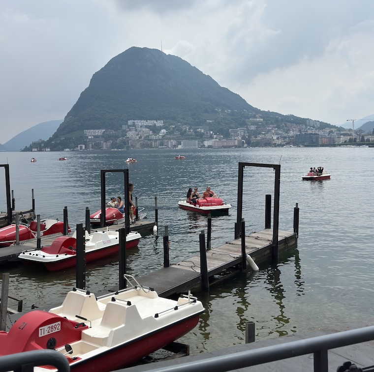 vista do monte bre e barcos no lago lugano